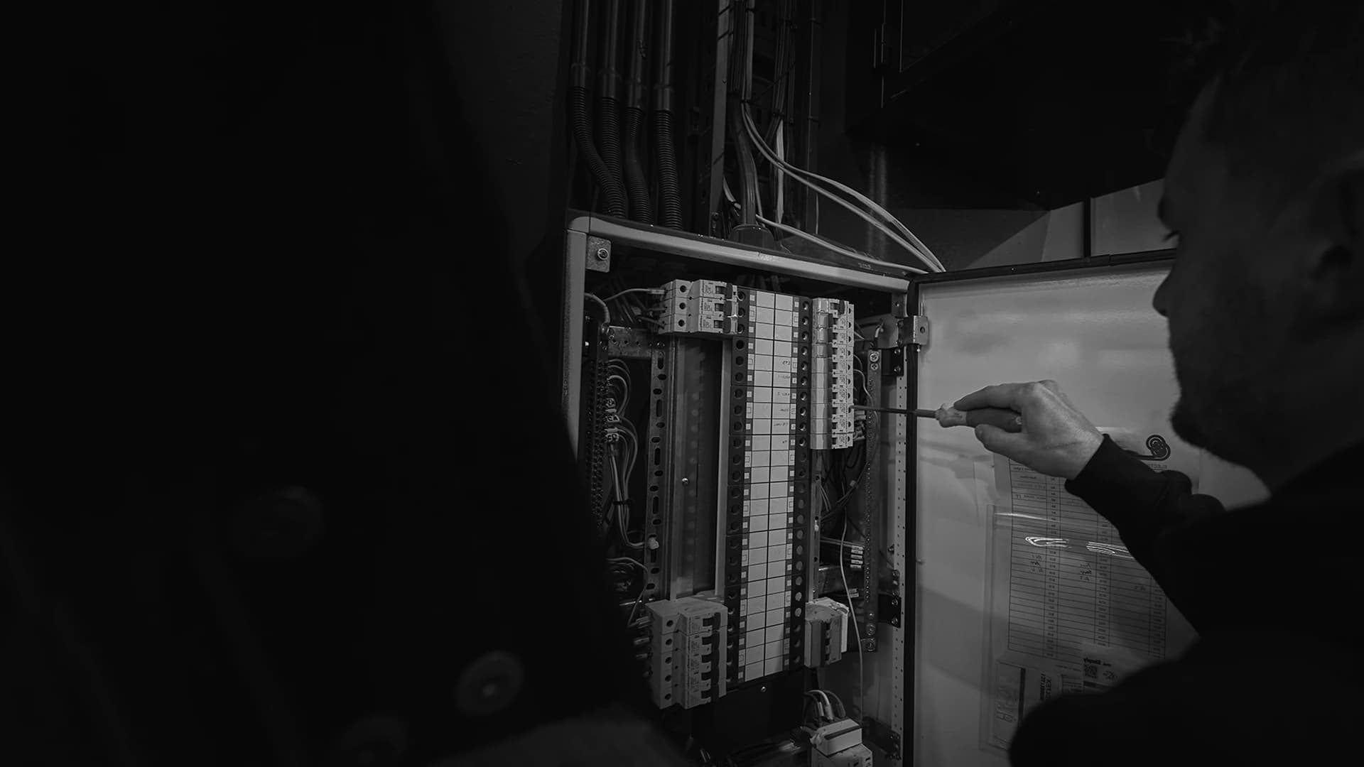Electric Avenue electrician working inside a switchboard, Tauranga